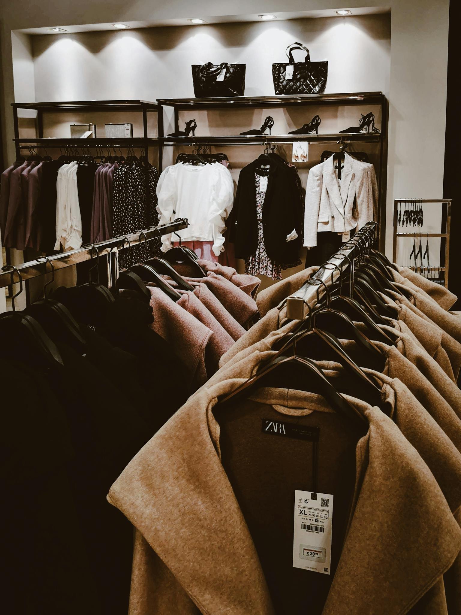 Stylish clothing racks in a modern store showcasing various garments.